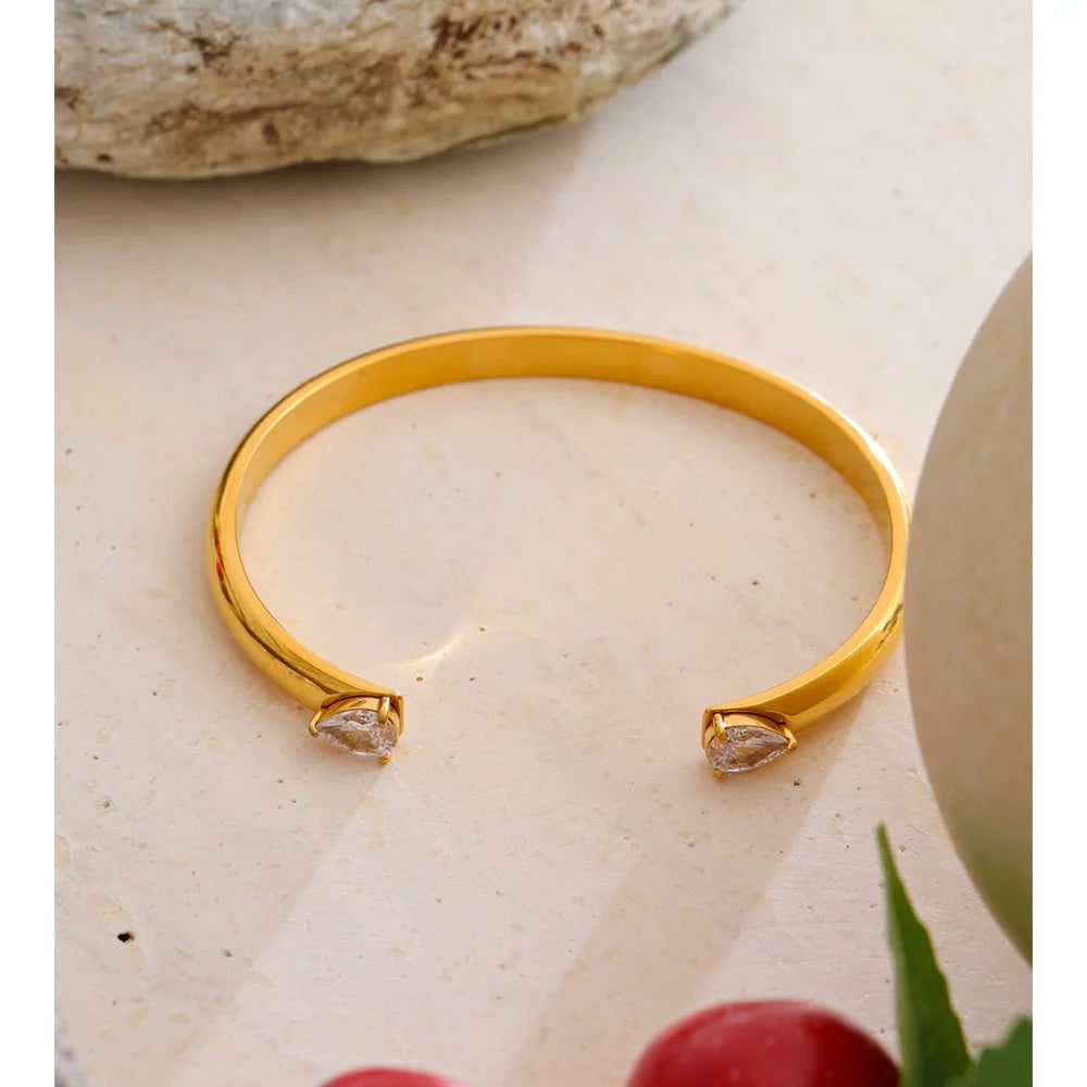 Brazalete abierto dorado con circonitas en acero inoxidable