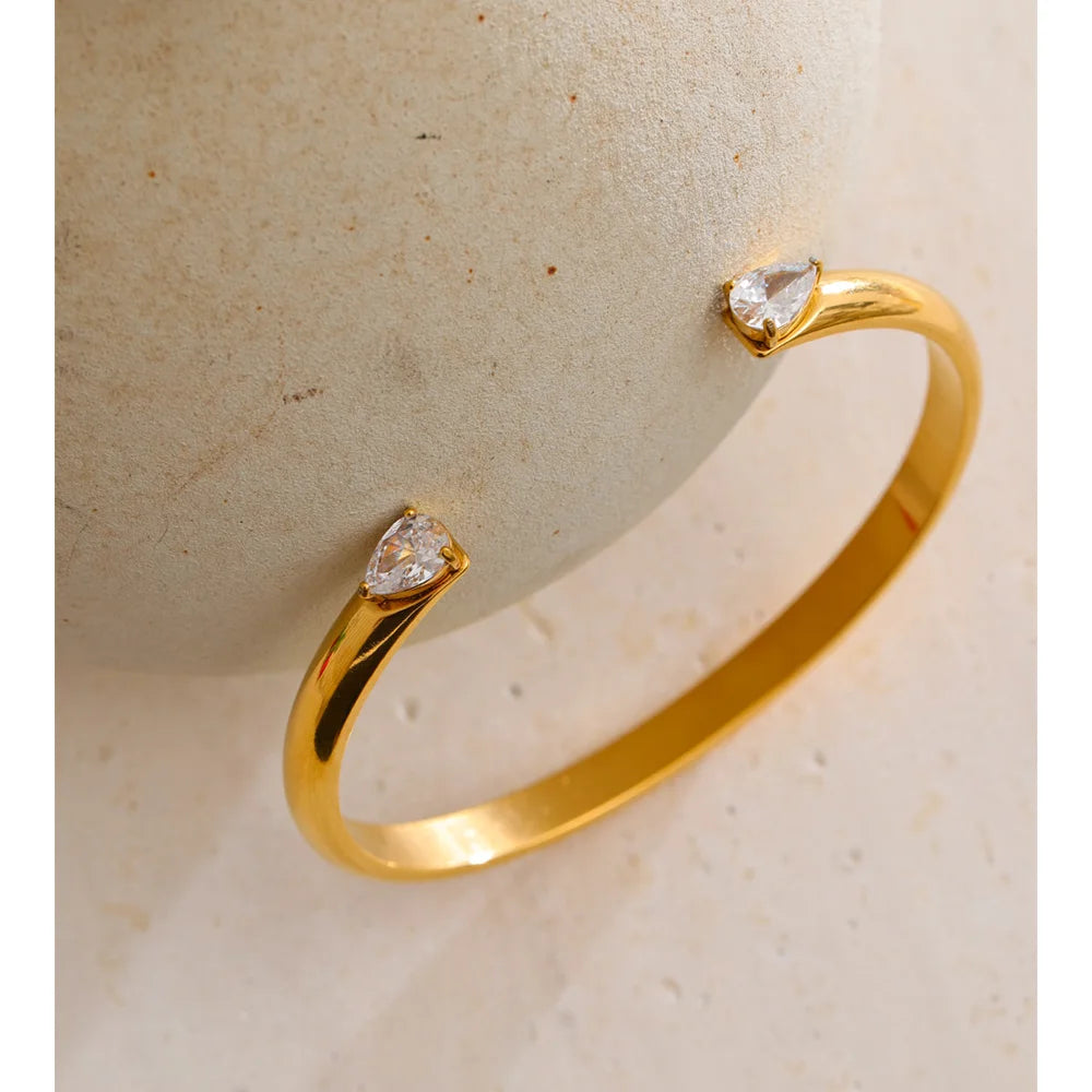 Brazalete abierto dorado con circonitas en acero inoxidable
